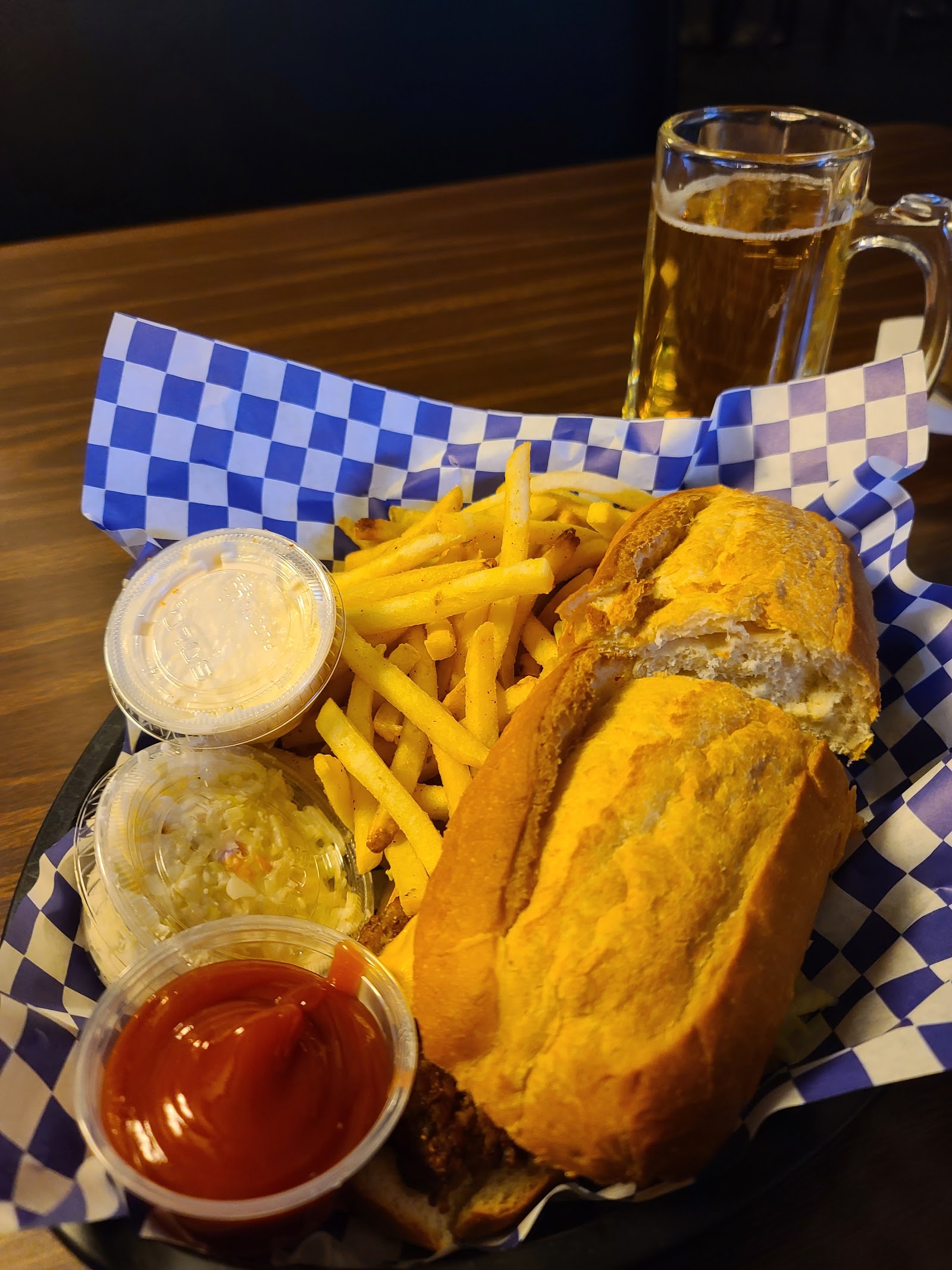 Sandwich basket with fries, slaw and a frosty mug