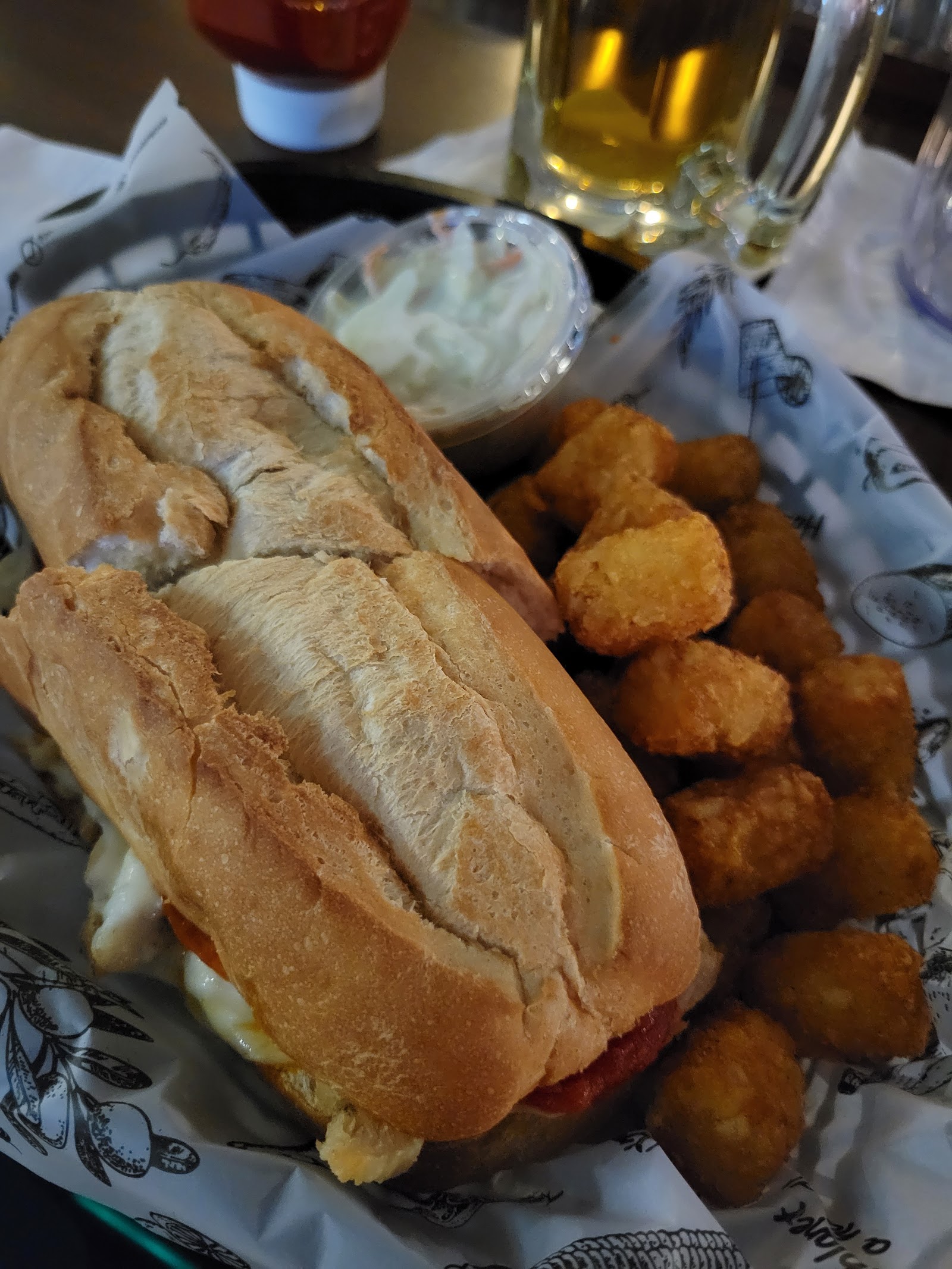 Hot sausage sandwich with tater tots at James Street Tavern